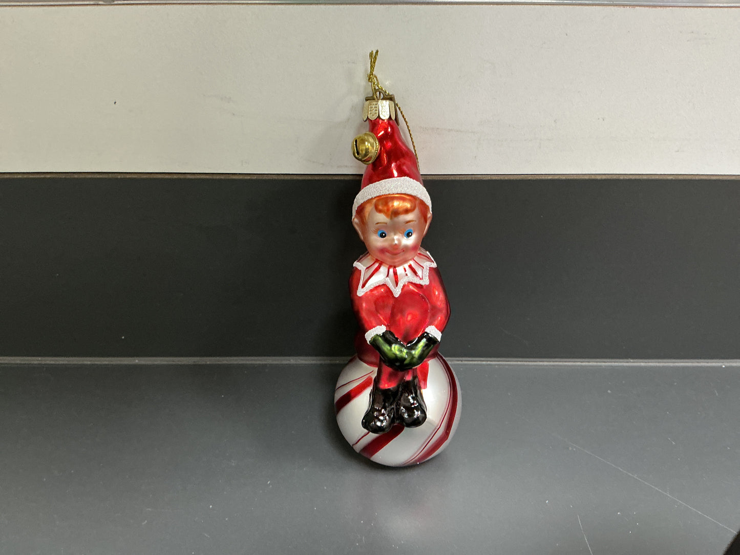 ELF SITTING ON AN ORNAMENT