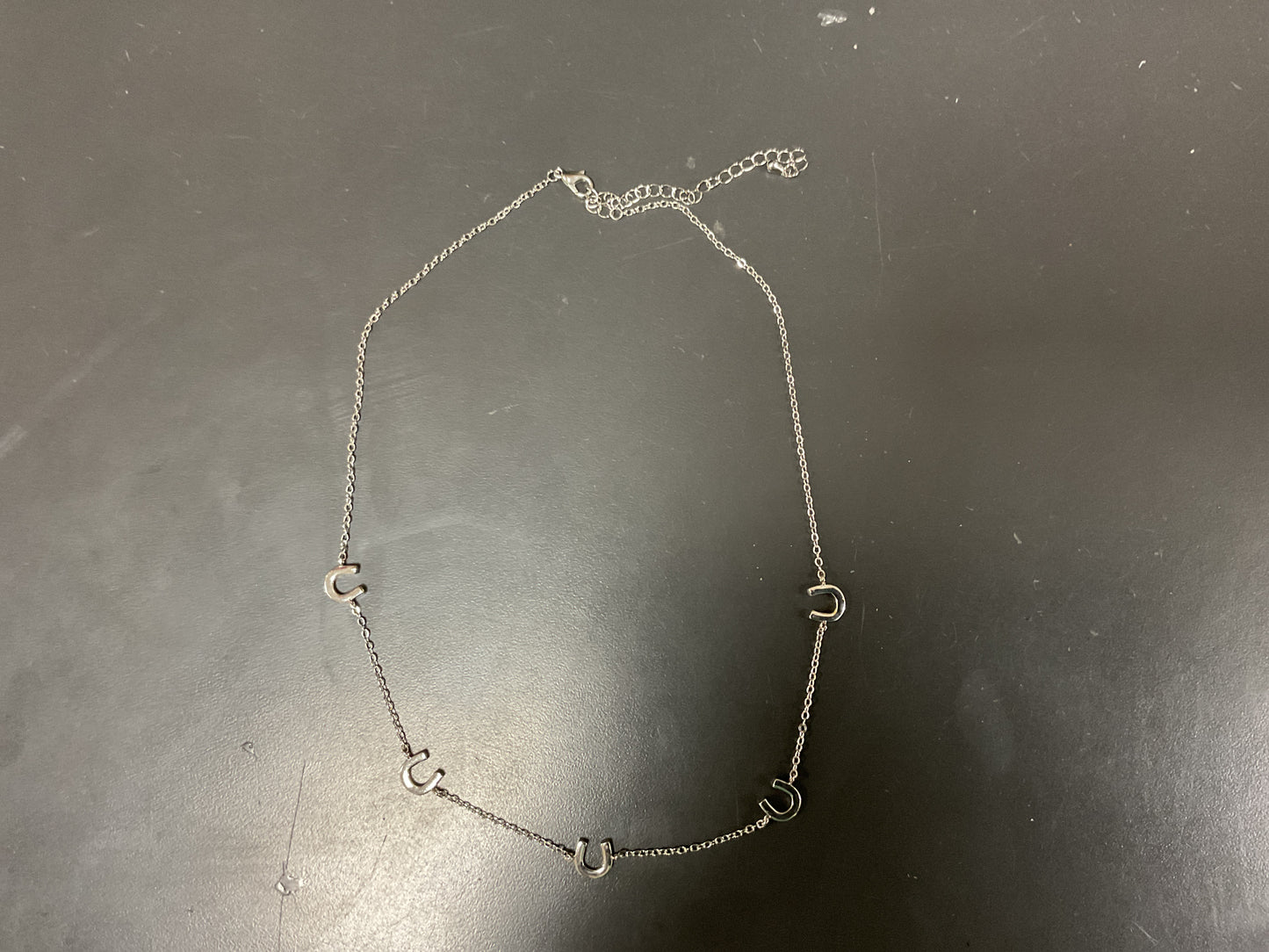 FIVE HORSE SHOE NECKLACE