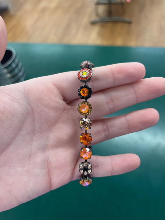 BLK BRCLT ORNG, PEACH, & CHMPGN STONES & FLWRS