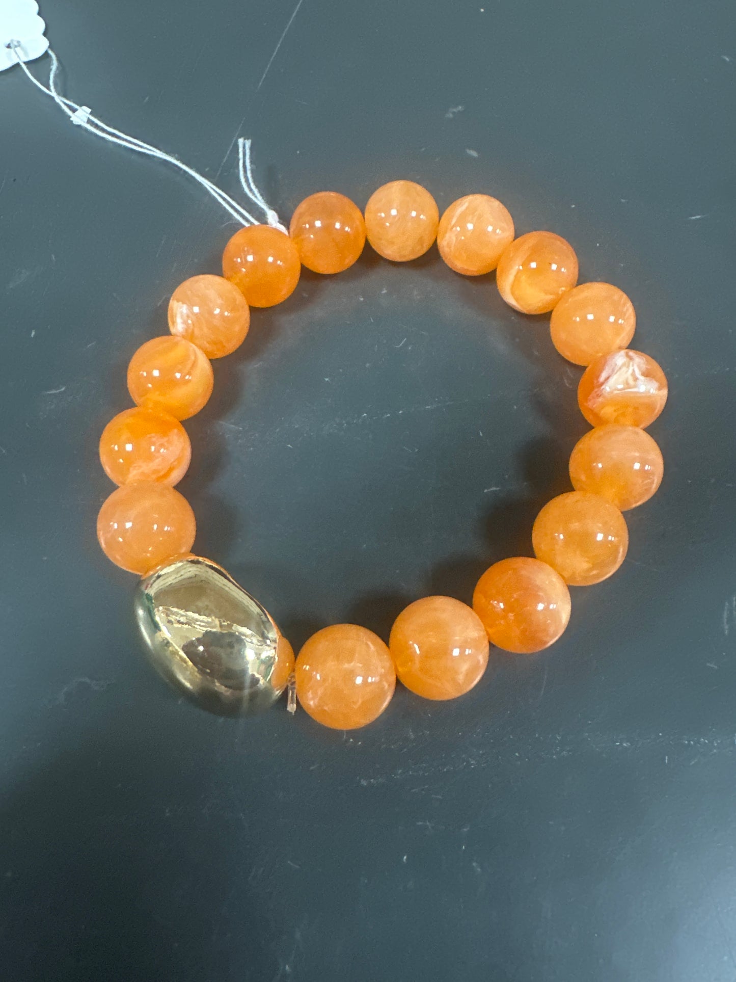 ORANGE BEADED BRACELET WITH GOLD EMBELLISHMENT