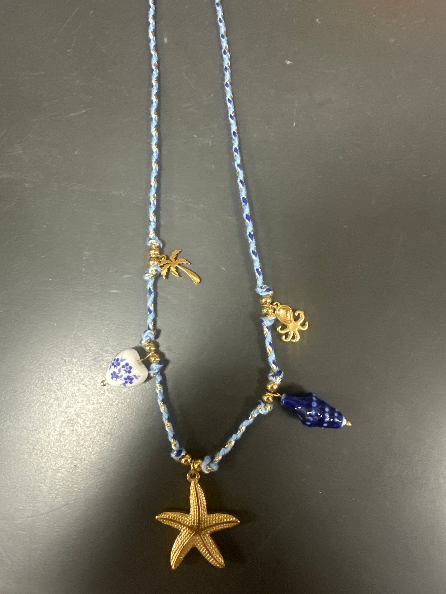 BLUE CORD NECKLACE WITH OCEAN THEME CHARMS