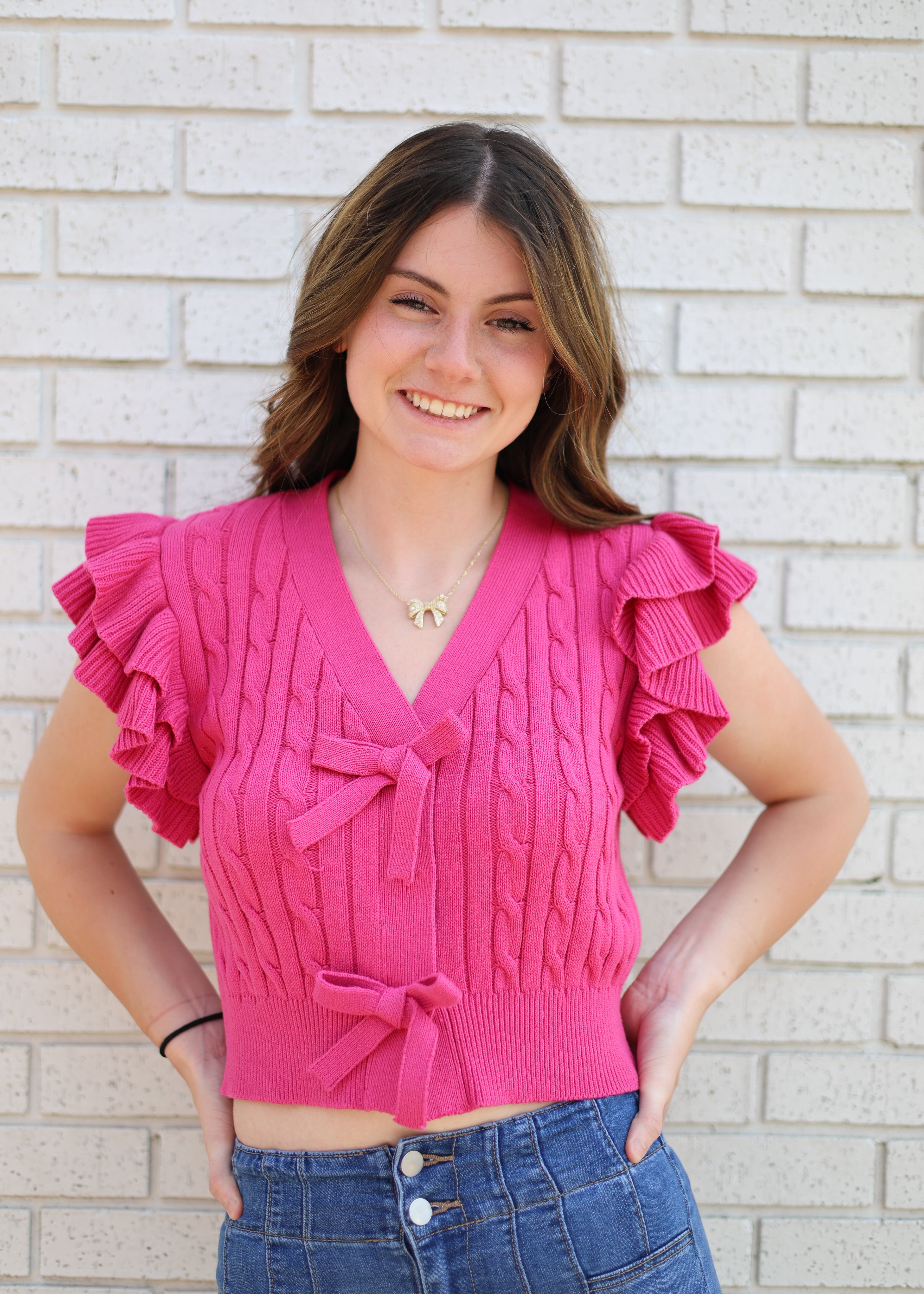 PINK CABLE KNIT SWEATER W/RUFFLE SLEEVE & BOW SNAP CLOSURE