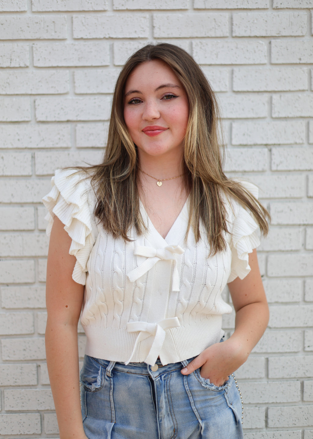 OFF WHITE CABLE KNIT SWEATER W/RUFFLE SLEEVE & BOW SNAP CLOSURE