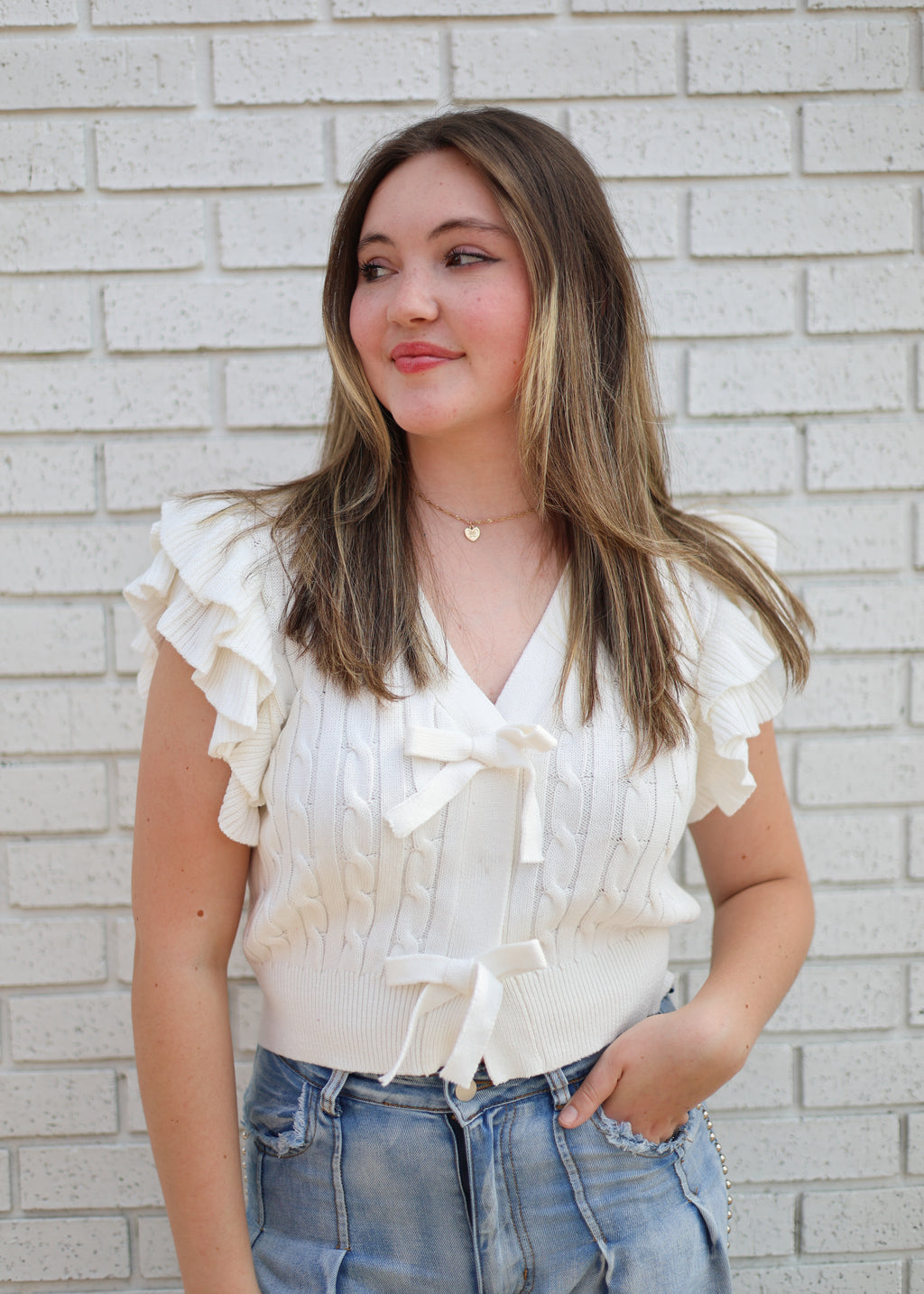 OFF WHITE CABLE KNIT SWEATER W/RUFFLE SLEEVE & BOW SNAP CLOSURE