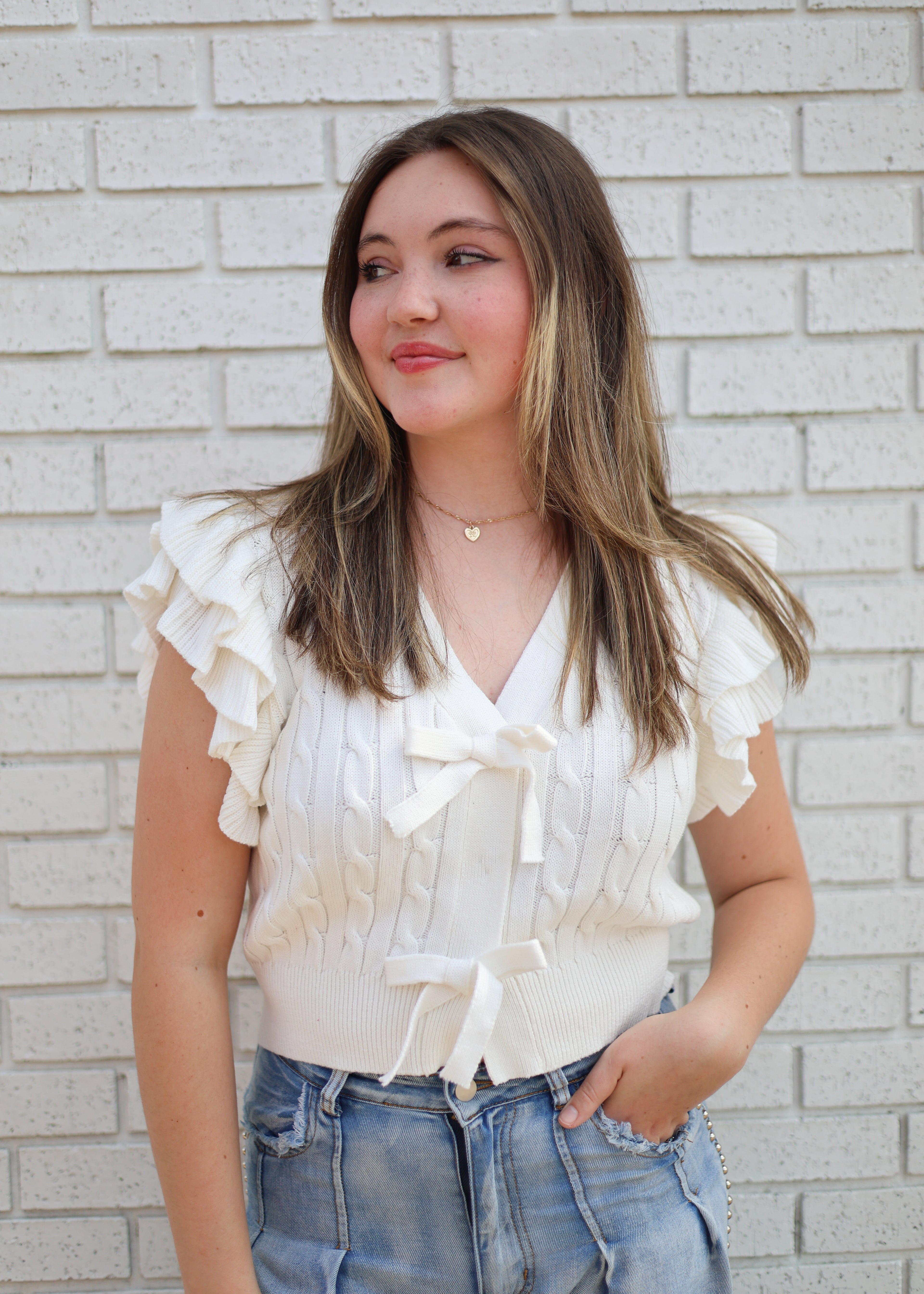 OFF WHITE CABLE KNIT SWEATER W/RUFFLE SLEEVE & BOW SNAP CLOSURE